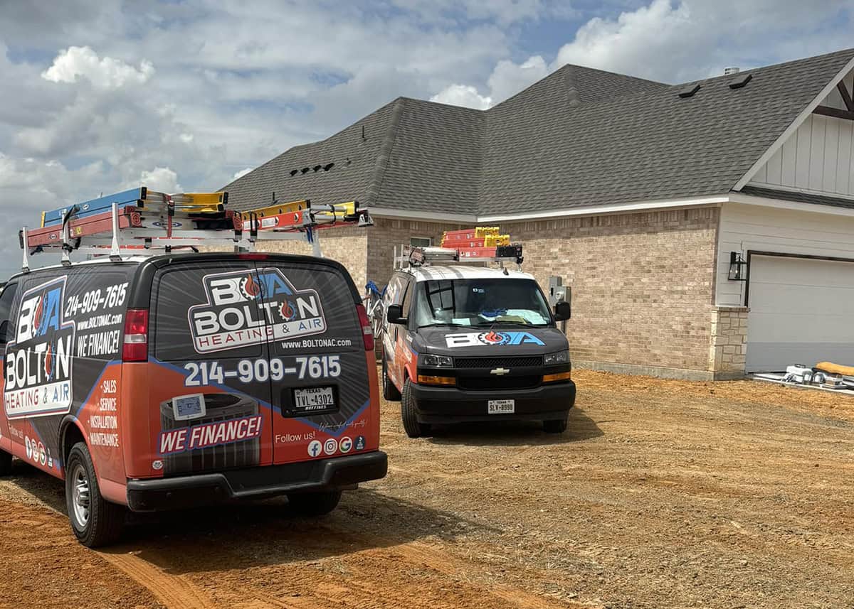 Bolton Heating & Air repair vans at a home in the Kaufman county