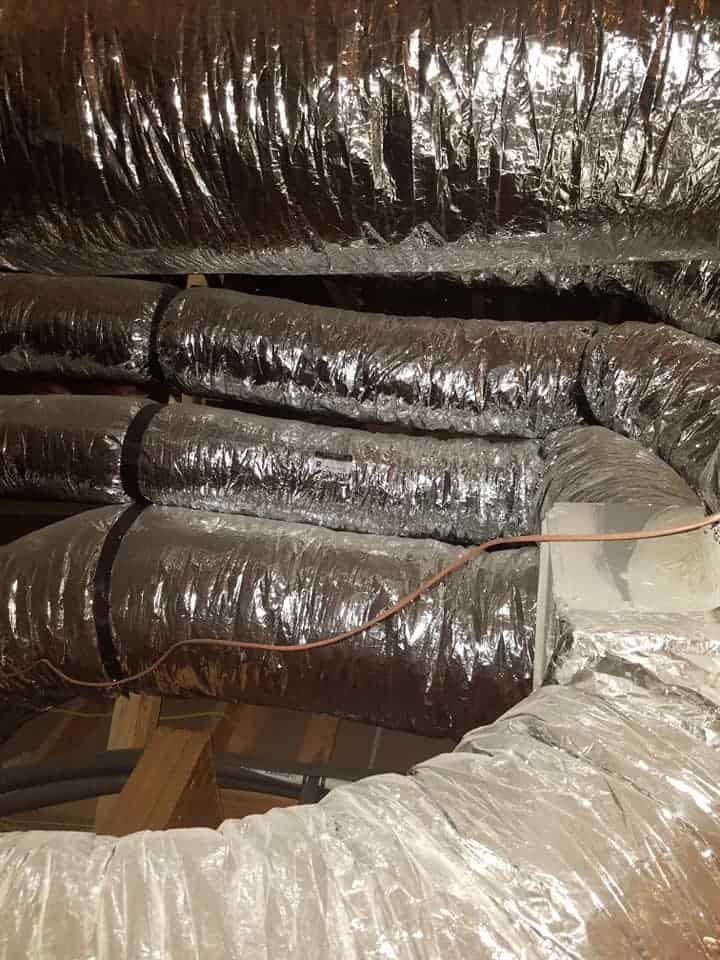 A technician from Bolton Heating & Air performing diagnostics on a malfunctioning HVAC unit in Forney